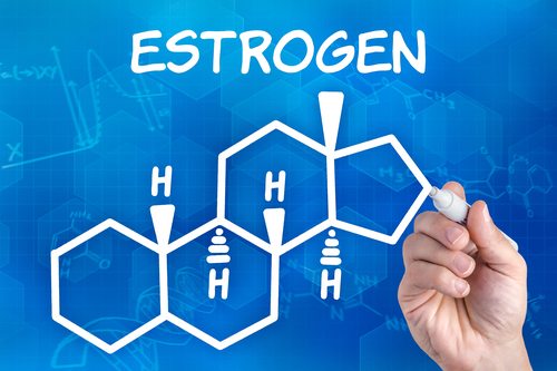 hand with pen drawing the chemical formula of Estrogen